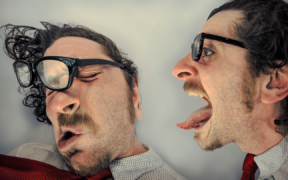 a photo of a Caucasian man in two images: on the right, it's him facing right 'yelling' with tongue out; on the left, it's him as if he had been hit, glasses askew and eyes shut
