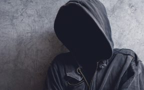 a person in a black hoodie, faceless