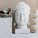 a statue of Buddha's head, next to two other statues