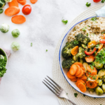 a table with a bowl filled with fresh vegetables