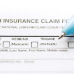 an insurance form with a blue pen placed on top