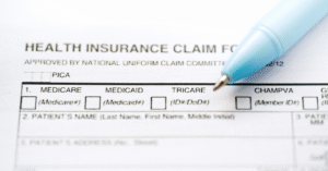 an insurance form with a blue pen placed on top